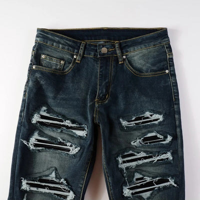 Vaqueros desgastados de lavado oscuro